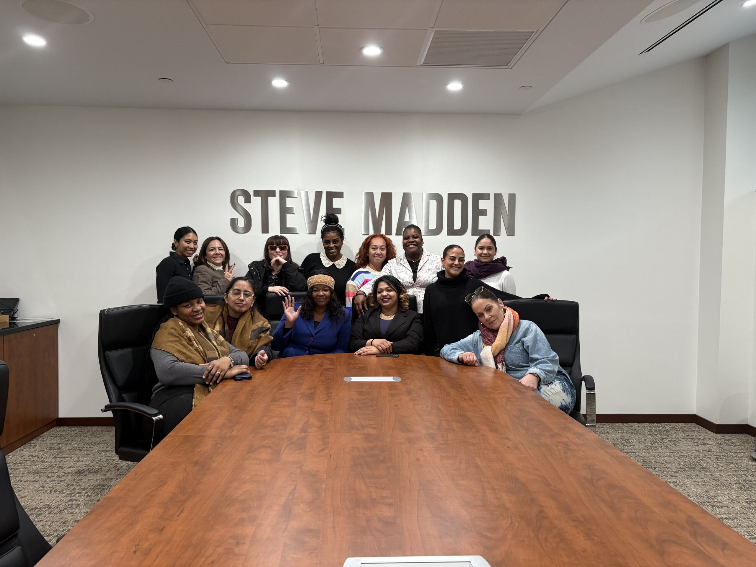 ladies standing up behind Steve Madden sign